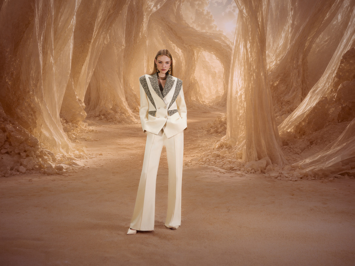 Model wearing a white Relic V-Shape Jacket in the gold world